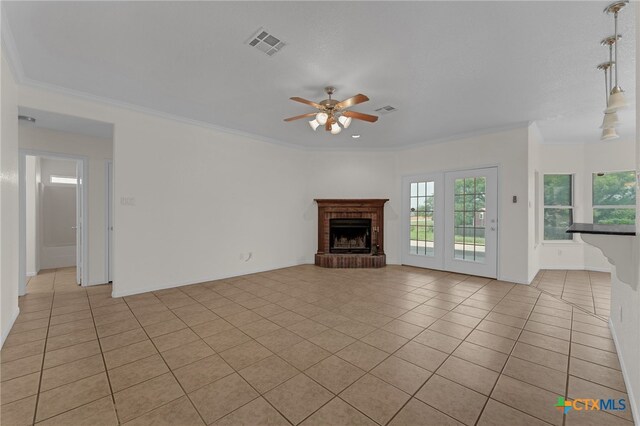 3302 Colorado Dr, Copperas Cove, TX 76522 - unfurnished living room with light tile patterned flooring, ceiling fan, crown molding, a brick fireplace, and baseboards