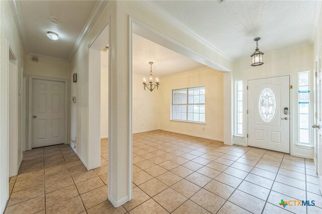 3302 Colorado Dr, Copperas Cove, TX 76522 - entrance foyer with a chandelier, light tile patterned flooring, plenty of natural light, and crown molding