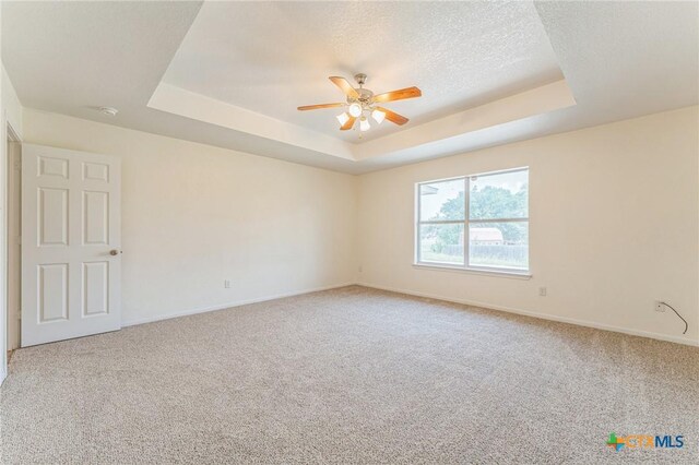 3302 Colorado Dr, Copperas Cove, TX 76522 - carpeted spare room featuring a tray ceiling, a ceiling fan, baseboards, and a textured ceiling