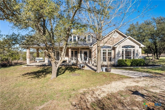 view of front of house featuring a front yard and covered porch