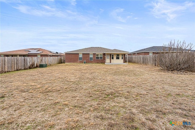 back of property featuring a lawn