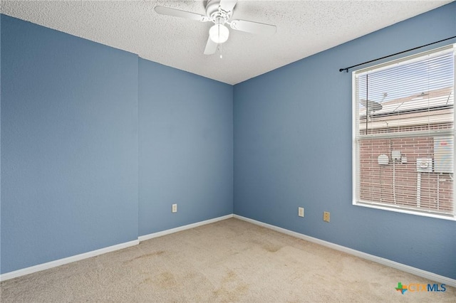 unfurnished room featuring ceiling fan, a textured ceiling, and light carpet