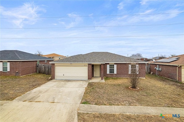 ranch-style home featuring a front lawn and a garage