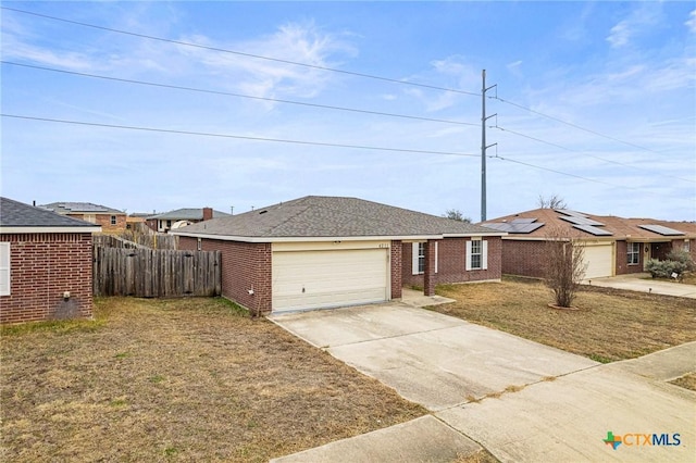 ranch-style home with a garage and a front lawn