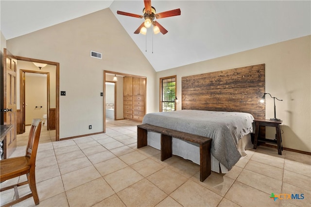 bedroom featuring ceiling fan, high vaulted ceiling, ensuite bath, and light tile patterned flooring