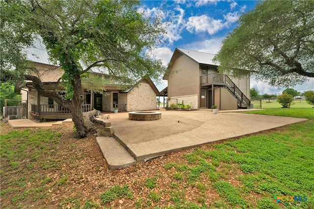 rear view of property featuring a patio and a lawn