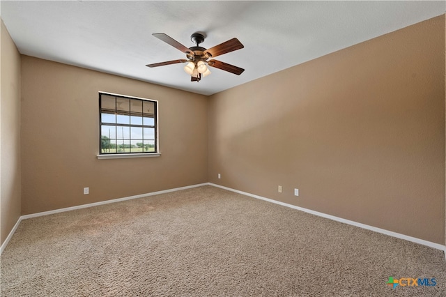 carpeted empty room featuring ceiling fan