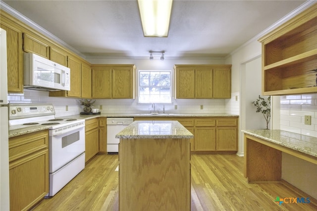 kitchen featuring white appliances, open shelves, a center island, a sink, and backsplash