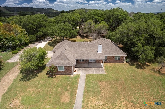 birds eye view of property with a wooded view