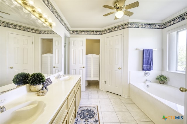bathroom featuring a closet, a sink, a ceiling fan, double vanity, and a garden tub