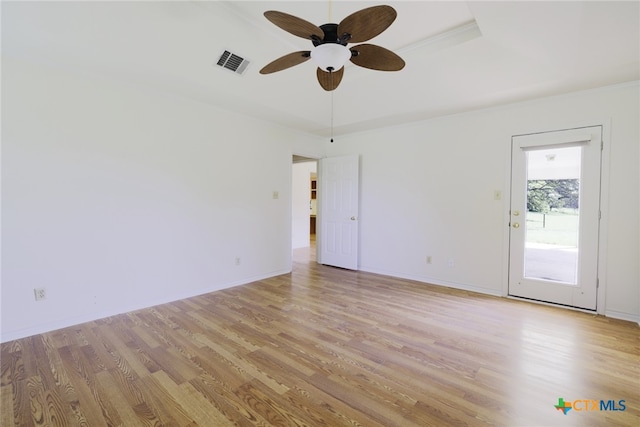 empty room with baseboards, visible vents, light wood-type flooring, and a ceiling fan