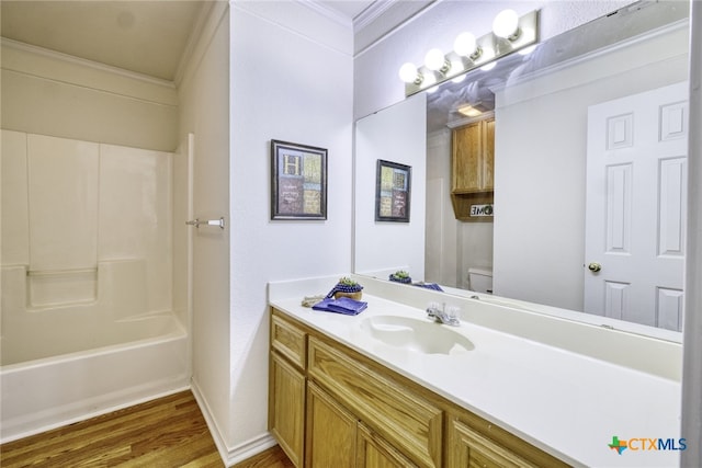 full bath with vanity, baseboards, ornamental molding, toilet, and wood finished floors