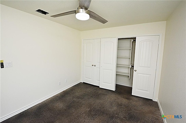 unfurnished bedroom featuring ceiling fan and dark colored carpet