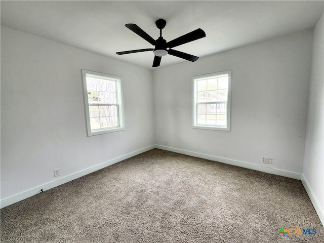 spare room featuring baseboards, ceiling fan, and carpet flooring