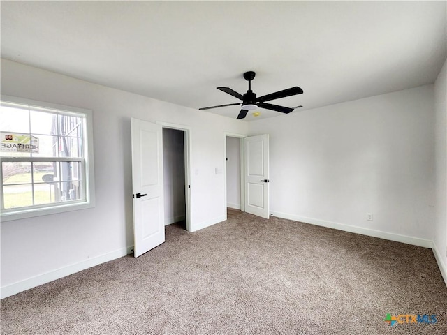 unfurnished bedroom with baseboards, carpet floors, and ceiling fan