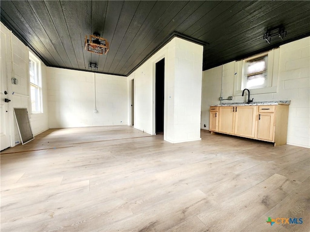 interior space with concrete block wall and wood ceiling