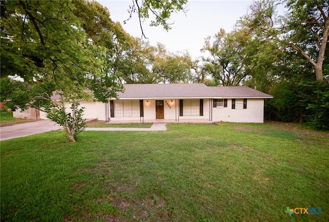 2405 Redwing Dr, Temple, TX 76502 - ranch-style house with driveway, a front yard, covered porch, and stucco siding