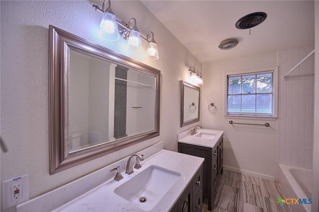 2405 Redwing Dr, Temple, TX 76502 - bathroom with two vanities and shower / washtub combination