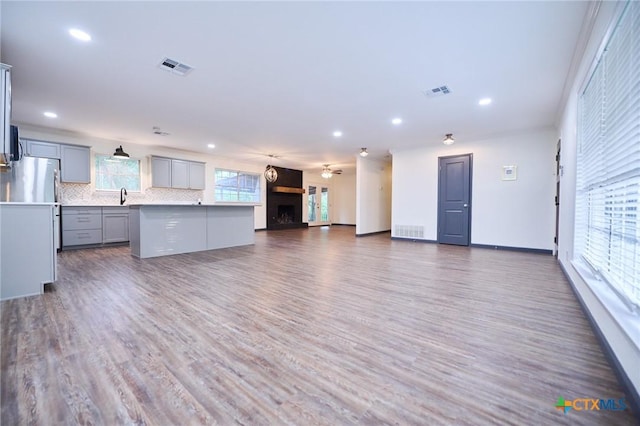 2405 Redwing Dr, Temple, TX 76502 - unfurnished living room featuring recessed lighting, wood finished floors, and a fireplace with raised hearth