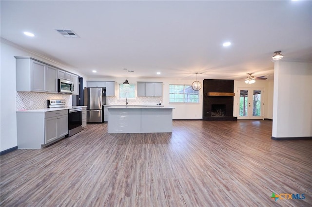 2405 Redwing Dr, Temple, TX 76502 - kitchen with appliances with stainless steel finishes, gray cabinets, open floor plan, decorative backsplash, and recessed lighting