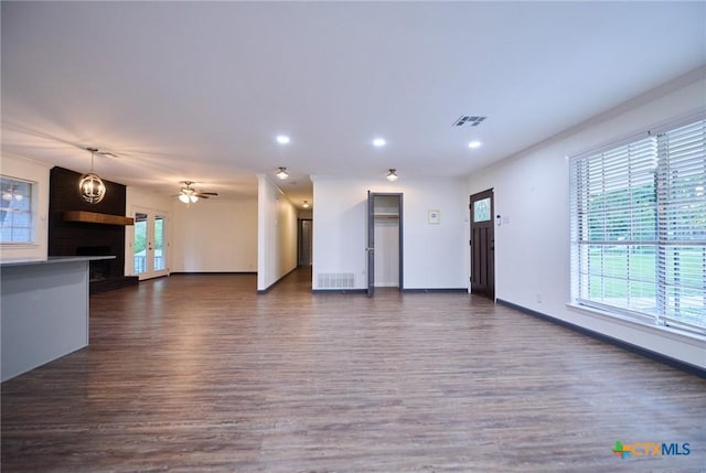 2405 Redwing Dr, Temple, TX 76502 - unfurnished living room featuring dark wood-style flooring, recessed lighting, ceiling fan, ornamental molding, and a fireplace