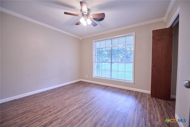 2405 Redwing Dr, Temple, TX 76502 - spare room featuring dark wood-type flooring, ornamental molding, and a ceiling fan