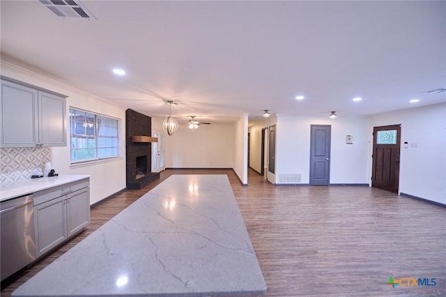 2405 Redwing Dr, Temple, TX 76502 - kitchen featuring dishwasher, a brick fireplace, recessed lighting, dark wood-style floors, and open floor plan