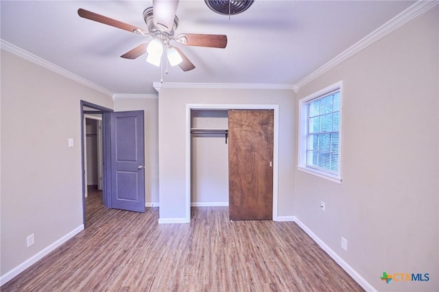 2405 Redwing Dr, Temple, TX 76502 - unfurnished bedroom with wood finished floors, ornamental molding, a closet, and a ceiling fan