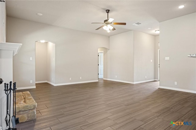 716 Kendra Dr, Temple, TX 76502 - unfurnished living room with arched walkways, a ceiling fan, wood finished floors, and recessed lighting