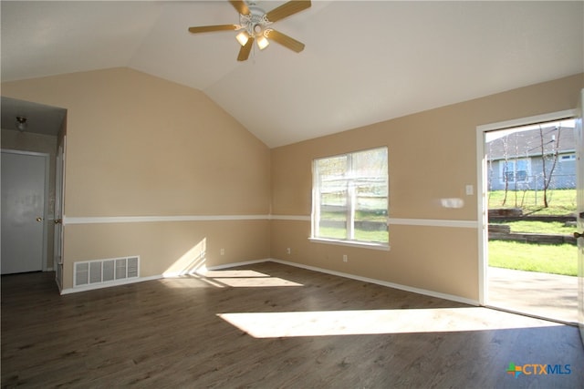 empty room with vaulted ceiling, ceiling fan, and dark hardwood / wood-style floors