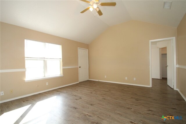 unfurnished room with ceiling fan, dark hardwood / wood-style flooring, and lofted ceiling