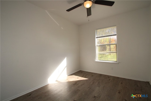 unfurnished room featuring ceiling fan and dark hardwood / wood-style flooring