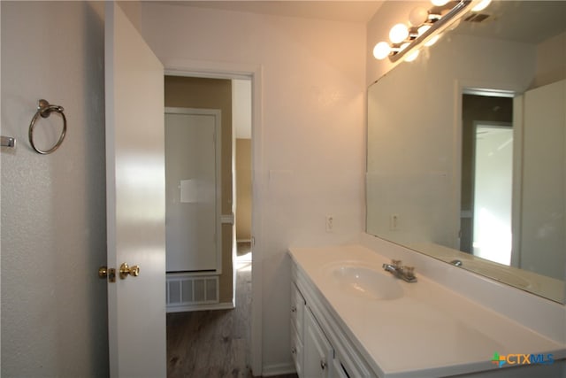 bathroom with vanity and hardwood / wood-style flooring