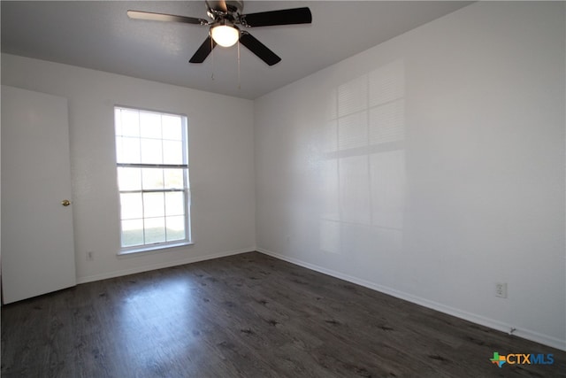 empty room featuring ceiling fan and dark hardwood / wood-style flooring