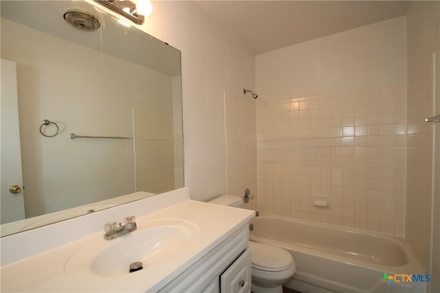 full bathroom with toilet, vanity, and tiled shower / bath