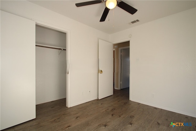 unfurnished bedroom with ceiling fan, dark hardwood / wood-style floors, and a closet