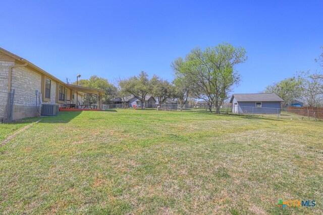 12204 Mustang Dr, Buda, TX 78610 - view of yard featuring a fenced backyard and central air condition unit