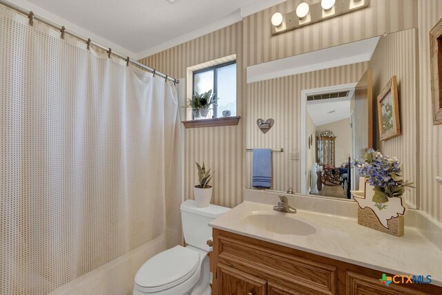 12204 Mustang Dr, Buda, TX 78610 - bathroom featuring visible vents, wallpapered walls, toilet, vanity, and shower / tub combo with curtain