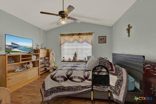 12204 Mustang Dr, Buda, TX 78610 - bedroom with a ceiling fan, vaulted ceiling, and wood finished floors