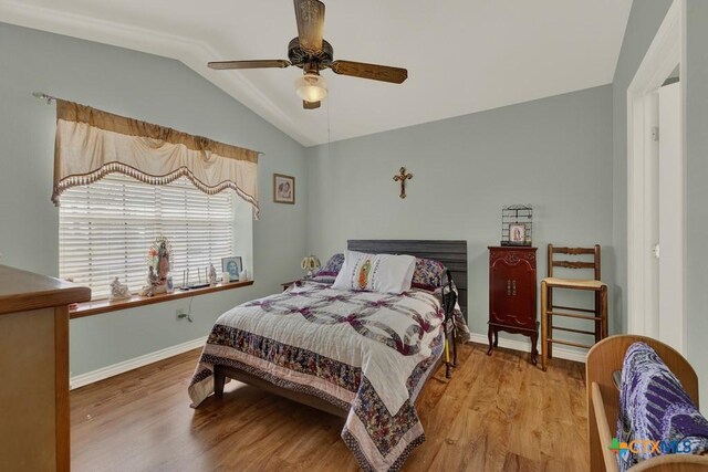 12204 Mustang Dr, Buda, TX 78610 - bedroom featuring baseboards, vaulted ceiling, wood finished floors, and a ceiling fan