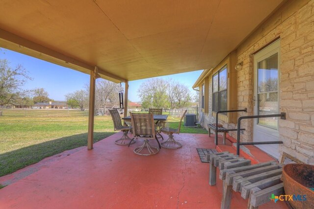 12204 Mustang Dr, Buda, TX 78610 - view of patio featuring central air condition unit and outdoor dining area