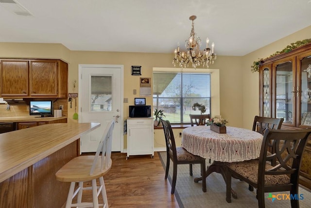 12204 Mustang Dr, Buda, TX 78610 - dining space featuring dark wood-style flooring, baseboards, a chandelier, and visible vents