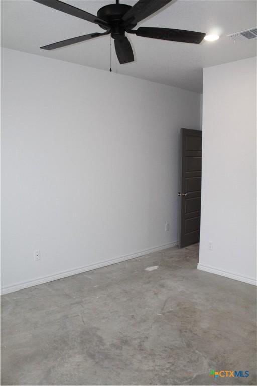 empty room featuring ceiling fan and concrete floors