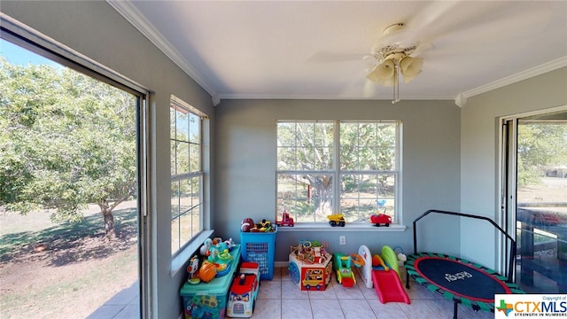 playroom featuring light tile patterned floors, ceiling fan, and crown molding