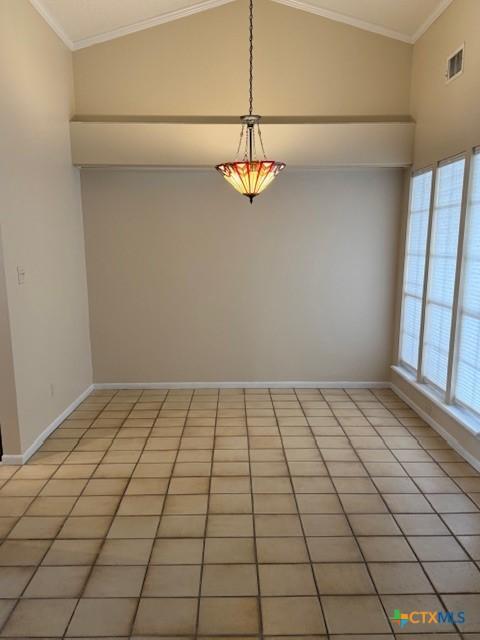 empty room featuring crown molding, baseboards, and light tile patterned floors