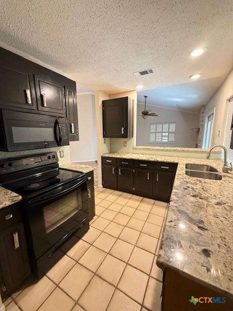 kitchen featuring light tile patterned floors, a sink, visible vents, a ceiling fan, and black appliances