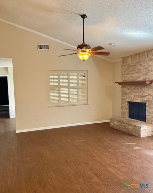 unfurnished living room with lofted ceiling, a brick fireplace, visible vents, and wood finished floors