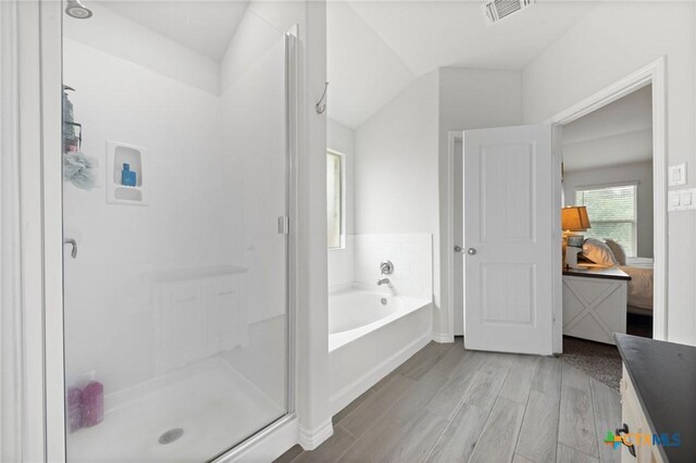 5702 Fenton Ln, Belton, TX 76513 - ensuite bathroom featuring wood finished floors, a shower stall, and a bath