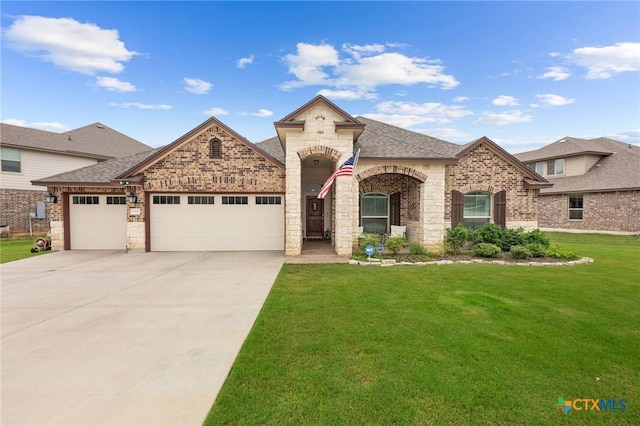 5702 Fenton Ln, Belton, TX 76513 - french country inspired facade featuring a front yard, an attached garage, brick siding, concrete driveway, and a shingled roof