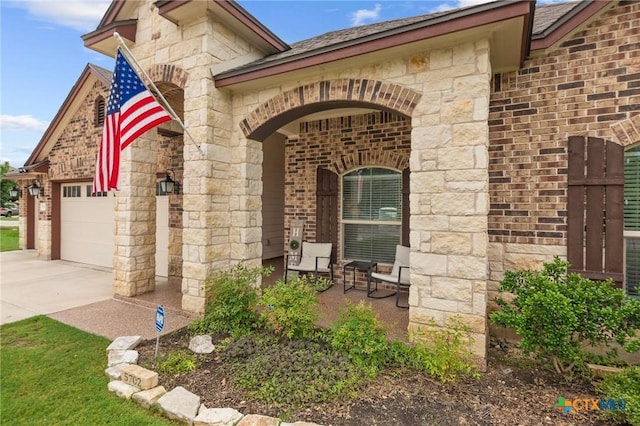 5702 Fenton Ln, Belton, TX 76513 - entrance to property with brick siding, stone siding, concrete driveway, and a garage